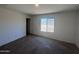 Bedroom with carpet, window, and access to walk-in closet and ensuite bathroom at 13142 E Aster Ln, Florence, AZ 85132