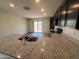 Open kitchen area with granite countertops and view into the breakfast nook and back yard at 13142 E Aster Ln, Florence, AZ 85132