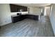 Stylish kitchen featuring granite countertops, stainless steel appliances, and wood-look floors at 13142 E Aster Ln, Florence, AZ 85132