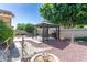 Picturesque backyard with gazebo, charming bridge, lush greenery, and decorative stone accents, perfect for outdoor enjoyment at 14436 W Ventura St, Surprise, AZ 85379