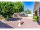 Backyard showcasing a gazebo, water feature, decorative items, and serene landscaping at 14436 W Ventura St, Surprise, AZ 85379