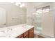 Bathroom featuring a double sink vanity and a glass-enclosed shower at 14436 W Ventura St, Surprise, AZ 85379