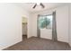 Carpeted bedroom featuring a walk-in closet and a window with sheer curtains at 14436 W Ventura St, Surprise, AZ 85379