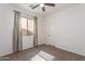 Carpeted bedroom with neutral walls and a window dressed with curtains for privacy at 14436 W Ventura St, Surprise, AZ 85379