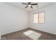 Bright, carpeted bedroom featuring a ceiling fan and a window for natural light at 14436 W Ventura St, Surprise, AZ 85379