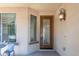 Inviting front entrance with decorative glass door, ambient lighting, and a cozy seating area at 14436 W Ventura St, Surprise, AZ 85379
