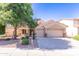 Charming single-story home featuring a well-manicured front yard, three-car garage, and inviting curb appeal at 14436 W Ventura St, Surprise, AZ 85379