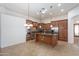 Open kitchen boasts stainless appliances, large center island, and plenty of cabinet storage at 14436 W Ventura St, Surprise, AZ 85379