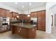 Gourmet kitchen features stainless appliances, spacious center island, and ample cabinet space at 14436 W Ventura St, Surprise, AZ 85379