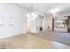 Bright living room boasts tile flooring and plush carpet, plus a cozy fireplace at 14436 W Ventura St, Surprise, AZ 85379
