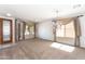 Inviting living room featuring a chandelier, large windows, and decorative window coverings at 14436 W Ventura St, Surprise, AZ 85379