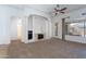 Cozy living room features fireplace, ample natural light, and access to the backyard at 14436 W Ventura St, Surprise, AZ 85379