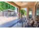 Inviting covered patio with comfortable seating and a gazebo overlooking the landscaped backyard at 14436 W Ventura St, Surprise, AZ 85379