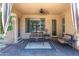 Cozy covered patio featuring comfortable seating, ceiling fan, and decorative curtains, creating a relaxing outdoor space at 14436 W Ventura St, Surprise, AZ 85379