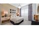 Cozy bedroom with elegant lighting, modern decor, and comfortable furnishings at 15044 W Gray Fox Trl, Surprise, AZ 85387