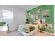 Inviting bedroom with green wall decor and a cozy bed, creating a serene space at 15044 W Gray Fox Trl, Surprise, AZ 85387
