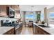 Modern kitchen featuring dark wood cabinets and stainless steel appliances at 15044 W Gray Fox Trl, Surprise, AZ 85387