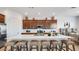 Kitchen with a large central island featuring bar stool seating and modern appliances at 15044 W Gray Fox Trl, Surprise, AZ 85387