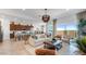 Bright, open-concept living room featuring modern furnishings, neutral colors, and seamless flow to the kitchen at 15044 W Gray Fox Trl, Surprise, AZ 85387