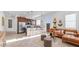 Open floor plan showcasing the living room with a modern kitchen and stylish decor at 15044 W Gray Fox Trl, Surprise, AZ 85387