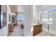 Bathroom featuring double vanities, modern fixtures, a walk-in shower, and an attached sitting room at 15044 W Gray Fox Trl, Surprise, AZ 85387