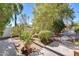 Lush backyard with mature trees and garden area, providing a tranquil oasis at 15608 N 57Th Dr, Glendale, AZ 85306