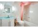 Bathroom featuring a turquoise sink, toilet and shower with pink floral wallpaper at 15608 N 57Th Dr, Glendale, AZ 85306