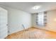 Bright bedroom featuring parquet floors, textured walls, and window with striped curtains at 15608 N 57Th Dr, Glendale, AZ 85306