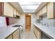Bright kitchen features white appliances, white counters, and ample cabinet space at 15608 N 57Th Dr, Glendale, AZ 85306