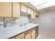 Bright kitchen featuring white countertops, skylight, and built in wine cooler at 15608 N 57Th Dr, Glendale, AZ 85306