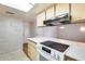 Open kitchen area featuring a flat cooktop and modern appliances at 15608 N 57Th Dr, Glendale, AZ 85306