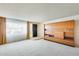 A spacious living room featuring a large built in shelving unit with room for storage at 15608 N 57Th Dr, Glendale, AZ 85306