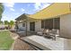 Relaxing covered back patio with neutral seating, overhead shade, and landscaped yard at 15969 W Adams St, Goodyear, AZ 85338