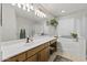 Bright bathroom with double sink vanity, soaking tub, and modern lighting at 15969 W Adams St, Goodyear, AZ 85338
