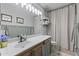 Bathroom featuring a large vanity, updated fixtures, and a decorative shower curtain at 15969 W Adams St, Goodyear, AZ 85338