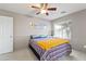 Cozy bedroom featuring a ceiling fan, wainscoting, and a comfortable bed at 15969 W Adams St, Goodyear, AZ 85338