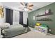 Stylish bedroom with black out curtains and organized shelves showcasing decorative items at 15969 W Adams St, Goodyear, AZ 85338