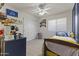 Bright bedroom offering built in shelves and a window with views of the front yard at 15969 W Adams St, Goodyear, AZ 85338