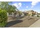 Inviting single-story home with a stone facade, desert landscaping, and an attached two-car garage at 15969 W Adams St, Goodyear, AZ 85338