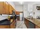 Well-equipped kitchen with wooden cabinets, stainless steel appliances, and a breakfast bar at 15969 W Adams St, Goodyear, AZ 85338