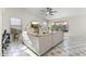 Bright living room with light tile floors, a ceiling fan, and a large window view at 15969 W Adams St, Goodyear, AZ 85338