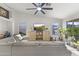 Bright living room featuring a large sectional sofa, vaulted ceilings, and plenty of natural light at 15969 W Adams St, Goodyear, AZ 85338