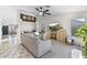 Comfortable living room featuring neutral tones, tile floors, and a mounted television at 15969 W Adams St, Goodyear, AZ 85338