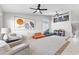 Bright living room with two ceiling fans, contemporary decor, and neutral carpet at 15969 W Adams St, Goodyear, AZ 85338