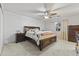 Comfortable main bedroom featuring a ceiling fan, carpet flooring, and ample natural light at 15969 W Adams St, Goodyear, AZ 85338