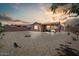 Desert backyard with stone landscaping, covered patio, and privacy fence, perfect for outdoor living at 16469 W Century Plant Dr, Surprise, AZ 85387