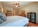 Cozy bedroom with wood floors, ceiling fan, and stylish furnishings, offering comfort and charm at 16469 W Century Plant Dr, Surprise, AZ 85387