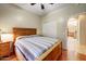 Inviting bedroom with wood floors, a comfortable bed, and an attached closet for easy access to storage at 16469 W Century Plant Dr, Surprise, AZ 85387