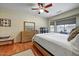 Comfortable bedroom with a neutral color palette, wood floors, and large windows for natural light at 16469 W Century Plant Dr, Surprise, AZ 85387