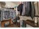 Spacious walk-in closet with ample storage, including shelves, rods, and shoe racks for organization at 16469 W Century Plant Dr, Surprise, AZ 85387